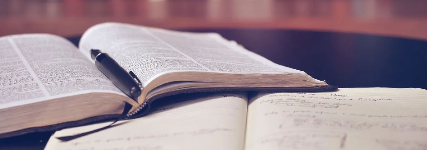 two books lay open on a table